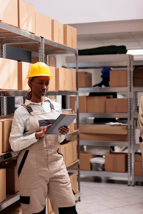 imgi 8 warehouse operator using inventory app digital tablet goods management young african american storehouse manager wearing protective overall chec